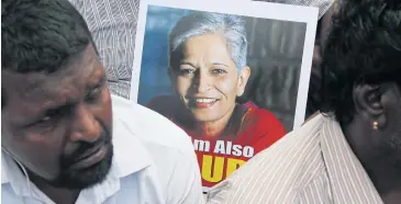  ?? AP ?? A participan­t holds a placard with a photograph of Indian journalist Gauri Lankesh at a protest in Bangalore yesterday against her killing.