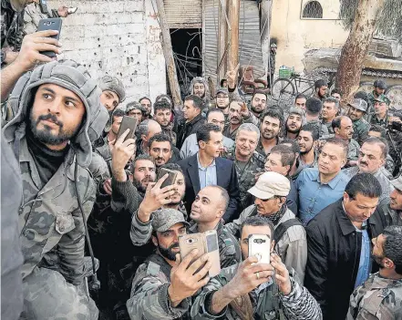  ?? EFE ?? Selfie. Soldados leais ao regime sírio recebem Bashar Assad em Ghouta Oriental: governo controla 80% da região