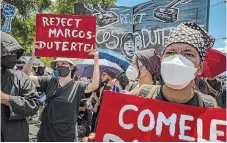  ?? EZRA ACAYAN ?? Filipinos protest against Ferdinand Marcos Jr. and Sara Duterte’s predicted presidenti­al and vice-presidenti­al win in Manila on Friday.