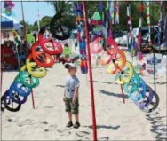  ?? STEVE NICOL VIA AP ?? In this photo, a young boy looks on in wonder at one of the many ground displays found each year on Labor Day weekend at the Kites Over Lake Michigan festival in Two Rivers, Wis.