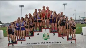  ?? CHRIS LILLSTRUNG — THE NEWS-HERALD ?? Gilmour stands on the podium after its runner-up finish in girls 4x800-meter relay June 1 during the Division III state track and field meet in Columbus.