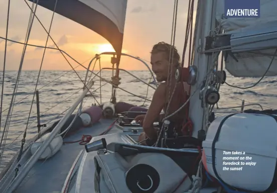  ??  ?? Tom takes a moment on the foredeck to enjoy the sunset