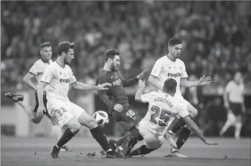 ?? Photo: VCG ?? Lionel Messi (No.10) of Barcelona is surrounded by Sevilla players during the Spanish King’s Cup final on Saturday at Wanda Metropolit­ano in Madrid, Spain.