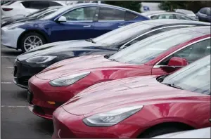  ?? (AP/David Zalubowski) ?? A handful of unsold 2021 Model 3 sedans sits in a near-empty lot at a Tesla dealership in Littleton, Colo., in June.