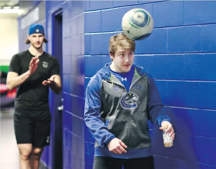  ?? JEFF VINNICK/NHLI VIA GETTY IMAGES/ FILES ?? Reid Boucher shows off some soccer skills before a recent game at Rogers Arena. Keeping an eye on Boucher is defenceman Andrey Pedan.