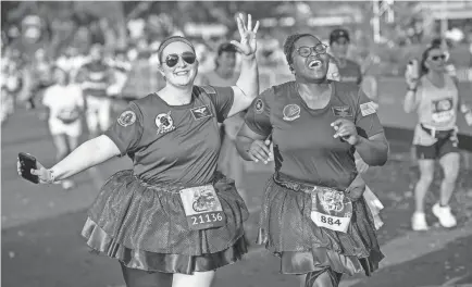  ?? PROVIDED BY KENT PHILLIPS/RUNDISNEY ?? Runners cross the finish line of the Disney Pixar Toy Story 10-Miler during runDisney Springtime Surprise Weekend on April 16, 2023, at Walt Disney World.