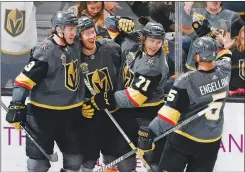  ??  ?? Teammates celebrate after center William Karlsson (71) scored against the San Jose Sharks on March 31 at T-mobile Arena. Karlsson’s third-period goal was the difference as the Knights won 3-2.