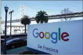  ?? JEFF CHIU / AP ?? The San Francisco-Oakland Bay Bridge is seen behind a Google sign at the company’s office in San Francisco on April 12.