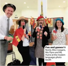  ??  ?? Fun and games Mr Norrie, Miss Coogans, Mrs Flynn and Ms Hume at the modern languages photo booth