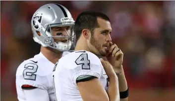  ?? AP PhoTo/BeN MArgoT ?? Oakland Raiders quarterbac­k Derek Carr (4) stands on the sideline next to quarterbac­k AJ McCarron (2) during the second half of the team’s NFL football game against the San Francisco 49ers in Santa Clara, Calif., on Thursday.