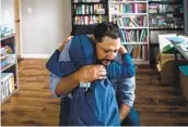  ??  ?? Rich Morales hugs his son Keiran goodbye before he attends first grade at Tierrasant­a Elementary School for his first day of in-person class on Monday.