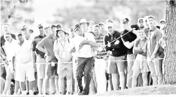  ??  ?? Patrick Reed of the United States plays a shot on the 17th hole during the second round of the 2018 Masters Tournament at Augusta National Golf Club on April 6, 2018 in Augusta, Georgia. - AFP photo