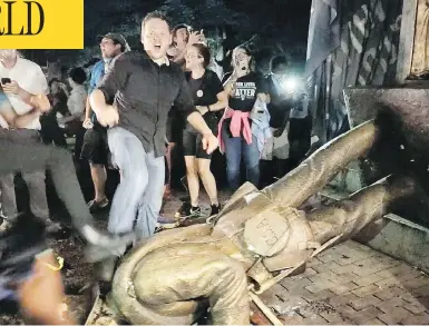  ?? JULIA WALL / THE NEWS & OBSERVER VIA AP ?? Protesters celebrate after the Confederat­e statue known as “Silent Sam” was toppled on the campus of the University of North Carolina in Chapel Hill, N.C., during a demonstrat­ion on Monday.