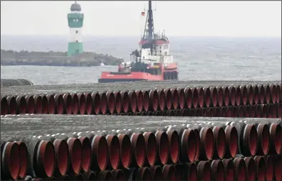  ?? The Associated Press ?? Pipes for the Nord Stream 2 Baltic Sea gas pipeline are stored on the premises of the port of Mukran near Sassnitz, Germany, on Dec. 4, 2020. Russia’s natural gas pipeline to Europe is built and ready to flow. But not so fast. The Nord Stream 2 pipeline faces a rocky road ahead. First there’s statement by the U.S. secretary of state that gas won’t flow if Russia launches military aggression against Ukraine.