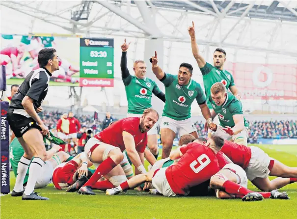  ??  ?? Making a point: Ireland’s players celebrate after Cian Healy forces his way over to give the home side a 27-13 lead in Dublin, but Wales refused to surrender until Jacob Stockdale (inset) finally killed them off with a late try