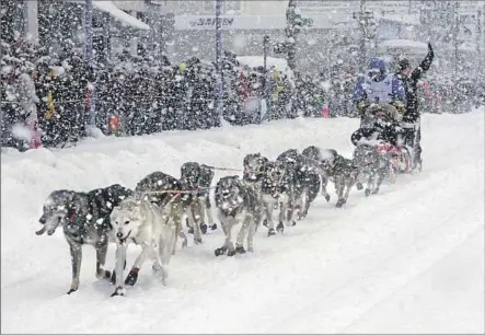  ?? Mark Thiessen Associated Press ?? JEFF KING and his team go through downtown Anchorage during the ceremonial start of the Iditarod Trail Sled Dog Race last March.
