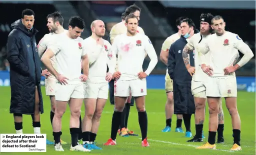  ?? David Rogers ?? England players look dejected after their defeat to Scotland