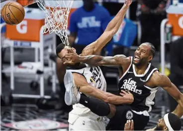  ?? — AP ?? Smack it: Los Angeles Clippers’ Kawhi Leonard loses the ball while going up for a dunk against Utah Jazz’s Rudy Gobert on Friday.