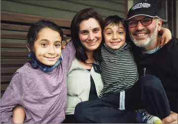  ?? Brian A. Pounds / Hearst Connecticu­t Media ?? Sarah Miller and Lee Cruz, of New Haven, enrolled their children, Pablo, 10, left, and Mateo, 6, in a Moderna COVID-19 vaccine trial at Yale University in New Haven. The family is seen here on Wednesday.