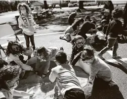  ??  ?? Children play with sand as part of the family activities during the celebratio­n at the Jewish Community Center, which opened in 1936.