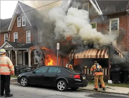  ?? SUBMITTED PHOTO – COATESVILL­E POLICE ?? Coatesvill­e firefighte­rs battle a house fire Monday afternoon in the 700 block of East Chestnut Street. Nobody was injured.