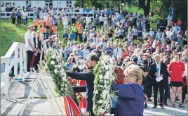  ?? AP PHOTO ?? Crown Prince Haakon of Norway and Prime Minister Erna Solberg lay wreaths during a ceremony on Utoya Island, Norway,. Norway is paying homage to the 77 people killed in a 2011 bombing and shooting rampage.