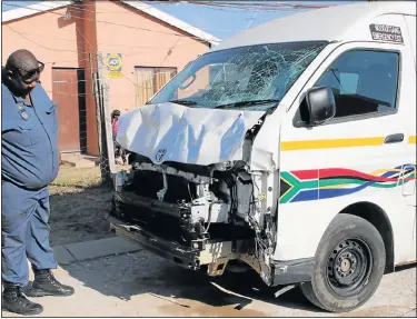  ?? Picture: FREDLIN ADRIAAN ?? FOUND ABANDONED: A policeman inspects the minibus taxi believed to have ploughed through a crowd of children who were having a party in Zwide