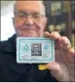  ?? Nelvin C. Cepeda San Diego U-T ?? PAUL GRISHAM shows an item from his billfold, returned after 53 years.