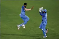  ?? ?? Mohammed Siraj (left) celebrates with wicketkeep­er Rishabh Pant. — ap