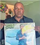  ?? PHOTO/ANNA NICHOLS AP ?? Peter Lyoya holds up a picture of his son Patrick Lyoya, 26, in his home in Lansing, Mich., last week.