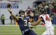  ?? TED S. WARREN — THE ASSOCIATED PRESS ?? Seattle Seahawks quarterbac­k Russell Wilson (3) passes under pressure from Atlanta Falcons’ Vic Beasley in the second half of an NFL football game Monday in Seattle.