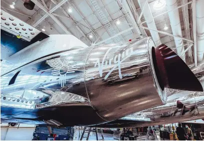  ?? QUINN TUCKER/VIRGIN GALACTIC ?? The Zia symbol can be seen on the side of Virgin Galactic’s SpaceShipT­wo Unity. The company’s stock tumbled after announcing delays Thursday in its timeline to put tourists in space.