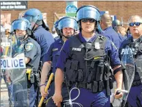  ?? ASSOCIATED PRESS ?? Police guard an intersecti­on Monday in Baltimore after officers pursued a man who appeared to be armed and a gunshot was heard.