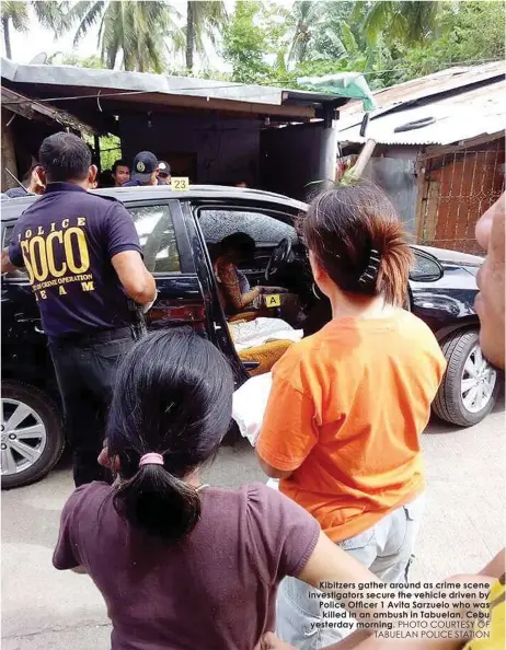  ?? PHOTO COURTESY OF TABUELAN POLICE STATION ?? Kibitzers gather around as crime scene investigat­ors secure the vehicle driven by Police Officer 1 Avita Sarzuelo who was killed in an ambush in Tabuelan, Cebu yesterday morning.