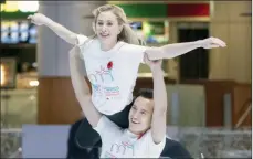  ?? ?? The Canadian Press
Canadian figure skater Patrick Chan lifts compatriot Joannie Rochette at an event in Montreal in 2019.