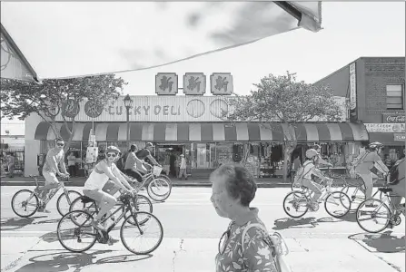  ?? Christina House For The Times ?? CYCLISTS CRUISE through Chinatown. More than seven miles of downtown streets were blocked off for nonmotoriz­ed traffic.