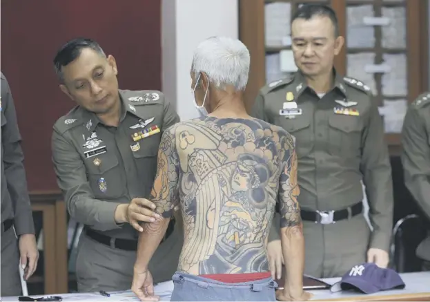  ??  ?? 0 Shigeharu Shirai’s full-body tattoos are displayed by police in Lopburi, central Thailand, after the Japanese alleged murderer’s arrest