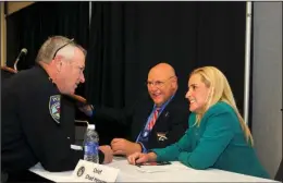  ?? The Sentinel- Record/ Mara Kuhn ?? POLICE TALK: J. R. Wilson, police chief for the city of Hope and first vice president of the Arkansas Associatio­n of Chiefs of Police, left, and Montie Sims, president, visit with Arkansas Attorney General Leslie Rutledge during the AACP’s 48th annual...