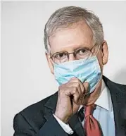  ?? DREW ANGERER/GETTY ?? Sen. Mitch McConnell’s use of masks stands in contrast to President Trump’s unwillingn­ess to wear face coverings.