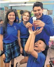  ?? COURTESY OF CAROL JOHANSEN ?? Seventh grade students, from left, Carisse P., Izabella C., Marcos A. and Justin M. work on a science project, something they were unable to do for most of the spring semester because of the COVID-19 shutdown.