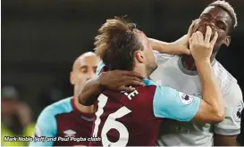  ??  ?? Mark Noble (left) and Paul Pogba clash