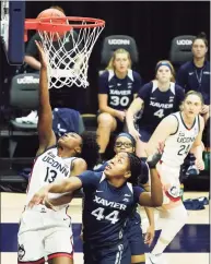  ?? David Butler II / Associated Press ?? UConn guard Christyn Williams (13) shoots and is fouled by Xavier forward Ayanna Townsend (44) in Saturday’s game in Storrs. Williams led all scorers with 24 points.