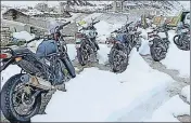  ??  ?? Two wheelers stuck in heavy snow on the ManaliLeh highway in Lahaul and Spiti on Monday. HT PHOTO