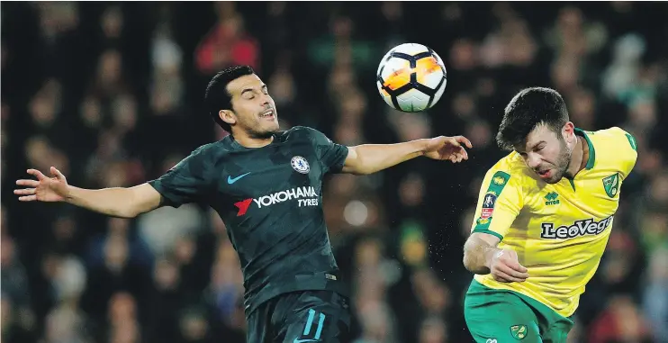  ?? — GETTY IMAGES ?? Norwich City’s Grant Hanley, right, heads the ball under pressure from Chelsea’s Pedro Ledesma during Saturday’s third-round FA Cup match in Norwich.