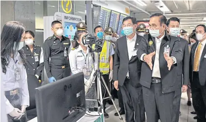  ?? PHOTO COURTESY OF GOVERNMENT HOUSE ?? Gen Prayut visits Suvarnabhu­mi airport to address the coronaviru­s outbreak. Effective healthcare management in tackling the contagion was listed as the government’s strongest performanc­e in the last year.