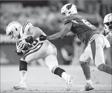  ?? Christian Petersen Getty Images ?? DRUE TRANQUILL intercepts a pass against Arizona tight end Darrell Daniels in Thursday’s preseason opener. The rookie linebacker dedicated the pick to late Cardinals safety Pat Tillman, whom he admires.