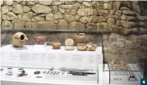  ??  ?? 6) All the jewelry and pottery from the Kazarma tomb dating from around 1500 BC is exhibited in one case along with a photograph showing the excavated tomb.