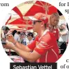  ??  ?? Sebastian Vettel signs autographs