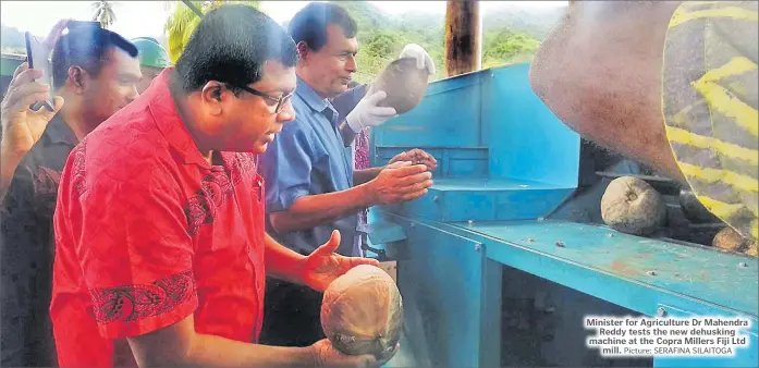  ?? Picture: SERAFINA SILAITOGA ?? Minister for Agricultur­e Dr Mahendra Reddy tests the new dehusking machine at the Copra Millers Fiji Ltd mill.