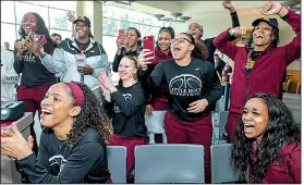  ?? Photo courtesy of Benjamin Krain, UALR athletics ?? UALR players react during an NCAA Tournament watch party Monday at the Jack Stephens Center in Little Rock. The Trojans will play Gonzaga on Saturday.